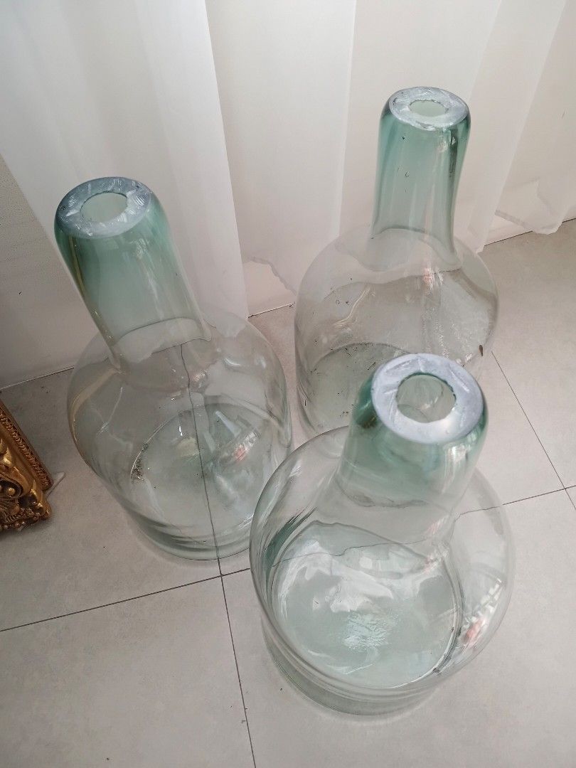 Damajuana/Demijohn Bottle (Category: Vases & Decorative Bowls) located in Quezon City. Submitted by pile.of.stuff (Listing ID 1467386225, Image 2). Description: Damajuana/Demijohn Bottle - Crafted from thick, heavy-duty recycled glass with a sturdy base - Ideal rustic decor piece for living room corners, entryways, or hallways - used once for an event - Dimensions: - 5 Units Available.