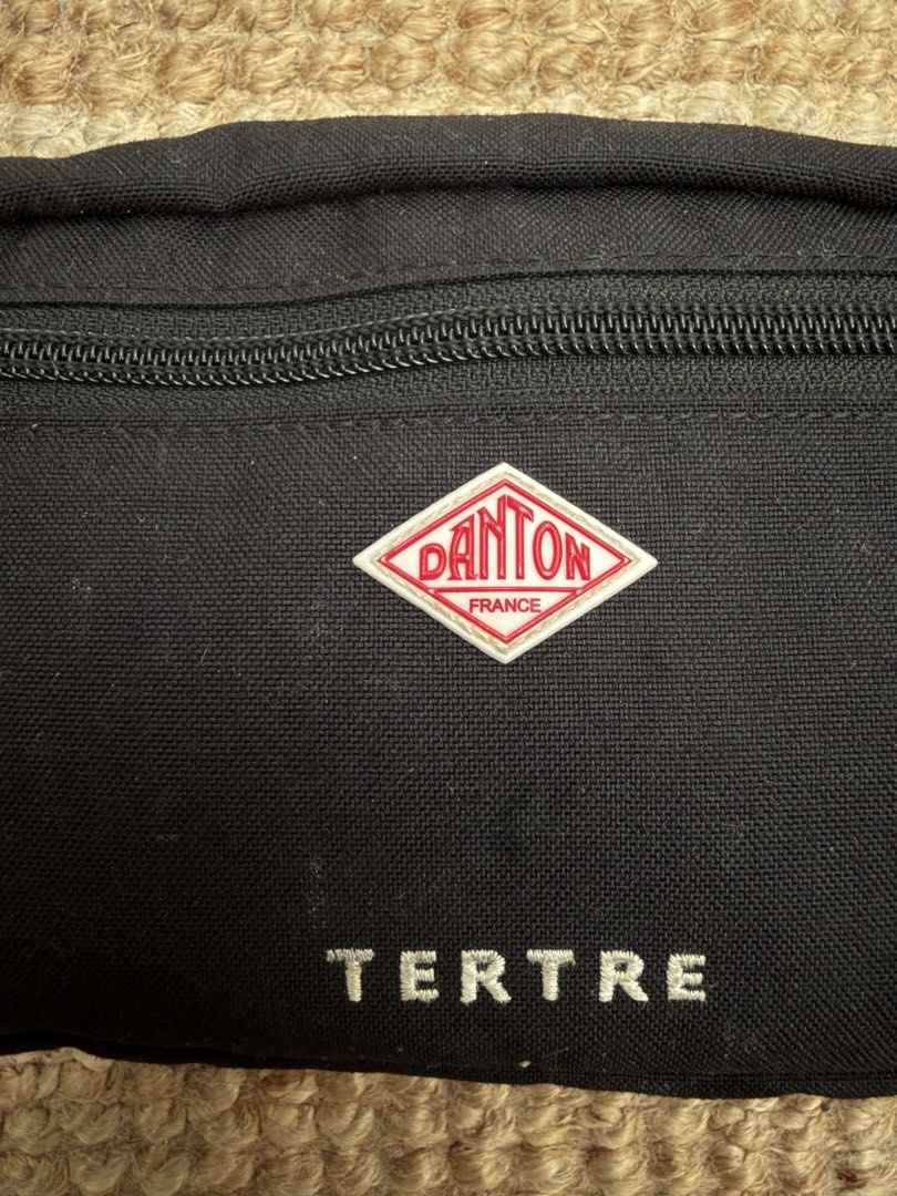 Danton Tertre Sling Bag (Category: Sling Bags) located in Santa Rosa. Submitted by acunicorn (Listing ID 1467387705, Image 2). Description: Danton France Tertre Sling Bag Needs wash Signs of wear on the zippers (see photos) Missing Danton keychain Danton’s simple and sporty shoulder pouch made with 500d Cordura nylon, featuring front embroidery in reference of one of Paris’s most famous squares, Place du Tertre. Zipper top closure Zippered front 