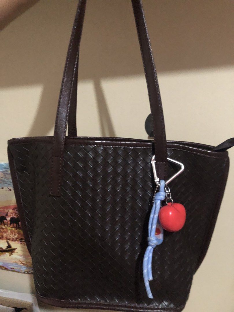 Dark Brown Woven Shoulder Bag Tote (Category: Shoulder Bags) located in Santa Rosa. Submitted by malyaolivera (Listing ID 1467475151, Image 2). Description: - Color: Dark brown - Material: Premium faux leather - Design: Elegant intricate woven exterior pattern - Closure: Top zipper with gold-toned hardware - Interior: Dark fabric lining with a convenient zippered side pocket - Accessories: Includes a playful blue braided cord and red charm - Usag