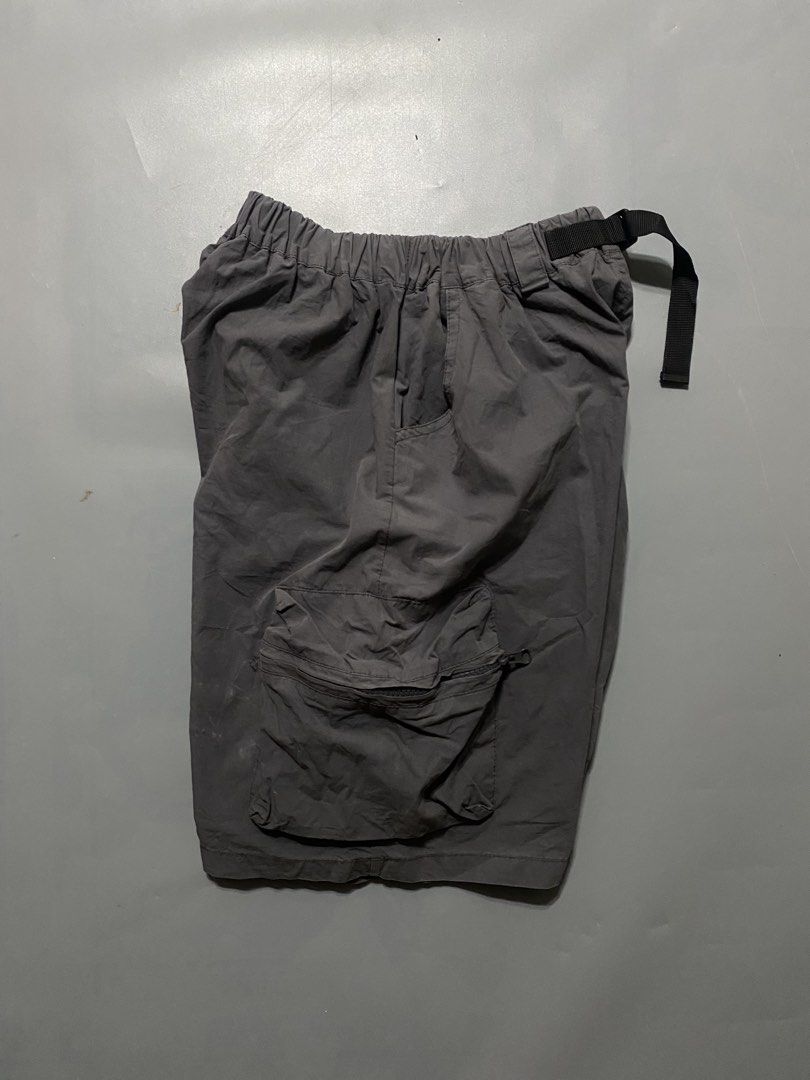 Dark Grey Cargo Shorts with Built-In Belt (Category: Shorts) located in Manila. Submitted by delunakenn94368 (Listing ID 1467509579, Image 3). Description: - Color: Dark grey - Material: Durable nylon - Fit: Relaxed fit, hits right at the knee - Waistband: Elastic waist with an adjustable black web belt and plastic buckle - Storage: Large zippered pockets on both sides - Versatility: Ideal for hiking, outdoor activities, street style, and everyda