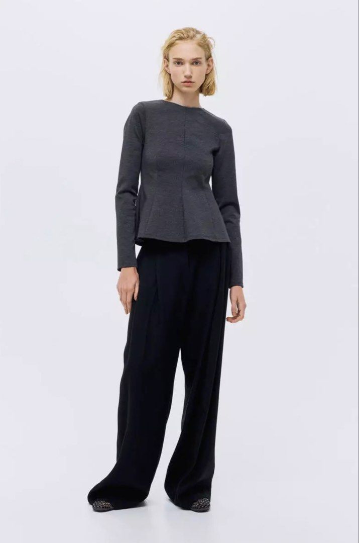 Dark Grey Peplum Long Sleeve Blouse (Category: Blouses) located in Manila. Submitted by katrinakatee (Listing ID 1467497254, Image 2). Description: - Color: Dark Grey - Style: Long sleeve with structured peplum waist and fitted silhouette - Neckline: Round neck - Closure: Back zipper - Material: Thick, shape-retaining jersey knit - Versatility: Perfect for both workwear and casual outings, easily paired with trousers or skirts.