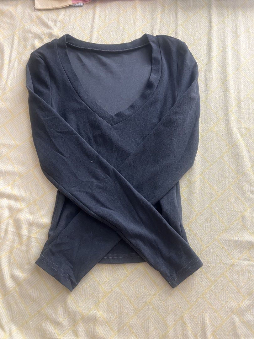 Dark Grey V-Neck Long Sleeve Top (Category: Longsleeves) located in Caloocan City. Submitted by queensproduct (Listing ID 1467454995, Image 1). Description: - Color: Dark grey - Style: Long sleeve with a deep V-neck and fitted silhouette - Fabric: Soft, stretchy, and comfortable for daily wear - Condition: Clean, no stains or rips - Pairing: Great with high-waisted jeans or skirts - Measurements available upon request.