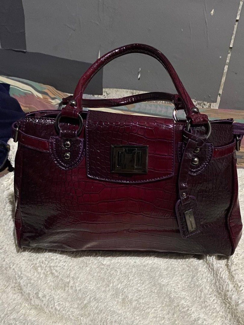 David Jones Burgundy Crocodile Embossed Handbag (Category: Luxury Bags & Wallets) located in Manila. Submitted by mabuyocarl (Listing ID 1467485729, Image 2). Description: - Color: Rich Burgundy with a glossy crocodile texture finish - Design: Structured shape with twin top handles and side strap details - Closure: Secure silver-tone twist lock on the front flap - Extras: Includes a matching branded luggage tag charm and durable metal hardware - 
