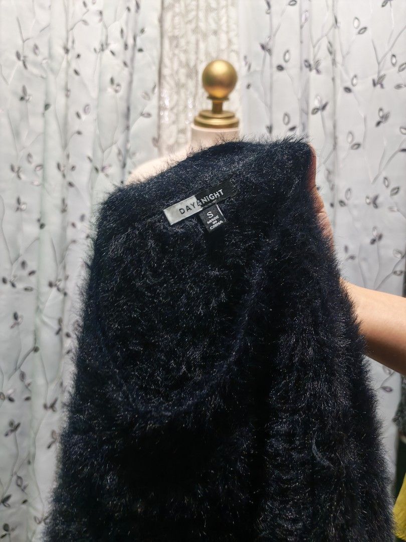 Day & Night Black Fluffy Knit Sweater Size S (Category: Longsleeves) located in Caloocan City. Submitted by _misskaye (Listing ID 1467474316, Image 2). Description: - Brand: Day & Night - Size: Small - Color: Black - Material: Soft fuzzy knit texture - Design: Crew neck, long sleeves, and front tie knot at the hem - Condition: Great, clean with no flaws.