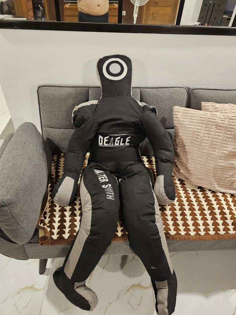 Deagle Master Smith Grappling Dummy (Category: Combat Sports) located in Makati City. Submitted by richpaul_ (Listing ID 1467534076, Image 1). Description: - Brand/Model: Deagle (Master Smith edition) - Color: Black and grey - Design: Includes arms, legs for submissions/throws, and a circular head target - Material: Heavy-duty, durable fabric construction - Ideal For: Wrestling, Brazilian Jiu-Jitsu (BJJ), and MMA solo training. P.S- iritang irita