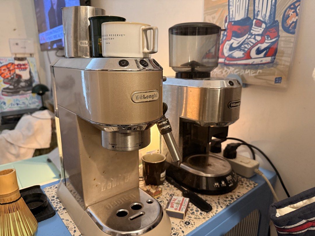 DeLonghi Dedica Espresso Machine and Grinder Set (Category: Coffee Machines & Makers) located in Mandaluyong City. Submitted by ohayouclub (Listing ID 1467378542, Image 1). Description: - DeLonghi Dedica espresso machine in champagne gold - Matching DeLonghi Dedica coffee grinder (black and stainless steel) - Includes multiple portafilters, filter baskets, tamper, and dosing rings - Used but works great, with minor scuffs from daily counter use.