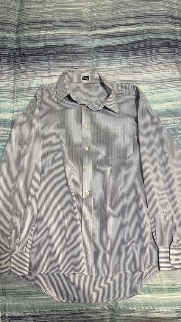 Dels Blue White Striped Long Sleeve Button-Up Shirt (Category: Formal Shirts) located in Quezon City. Submitted by kobeeeee_12 (Listing ID 1467530452, Image 1). Description: - Brand: Dels - Design: Blue and white stripes with classic collar and front button closure - Features: Single chest pocket, long sleeves with button cuffs, structured fit - Measurements: Length ~30 inches, Shoulder width ~18 inches - Versatility: Ideal for office wear or sma