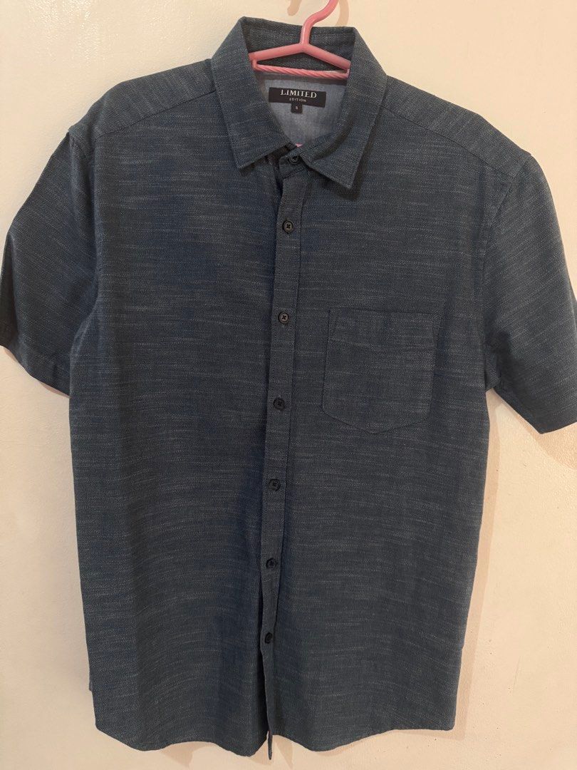 Denim Blue Short Sleeve Button-Down Polo (Category: Formal Shirts) located in Quezon City. Submitted by vibelane_shop (Listing ID 1467421739, Image 3). Description: - Brand: Limited - Color: Dark blue - Size: Small (tag on collar) - Features: Short sleeves, front button-down closure with dark buttons, single left chest pocket, curved hemline - Measurements: ~27 inches in length, ~20 inches across the chest - Condition: Excellent, stylish and read