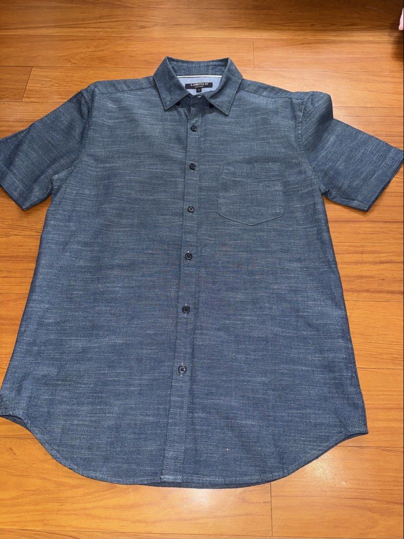 Denim Blue Short Sleeve Button-Down Polo (Category: Formal Shirts) located in Quezon City. Submitted by vibelane_shop (Listing ID 1467421739, Image 1). Description: - Brand: Limited - Color: Dark blue - Size: Small (tag on collar) - Features: Short sleeves, front button-down closure with dark buttons, single left chest pocket, curved hemline - Measurements: ~27 inches in length, ~20 inches across the chest - Condition: Excellent, stylish and read