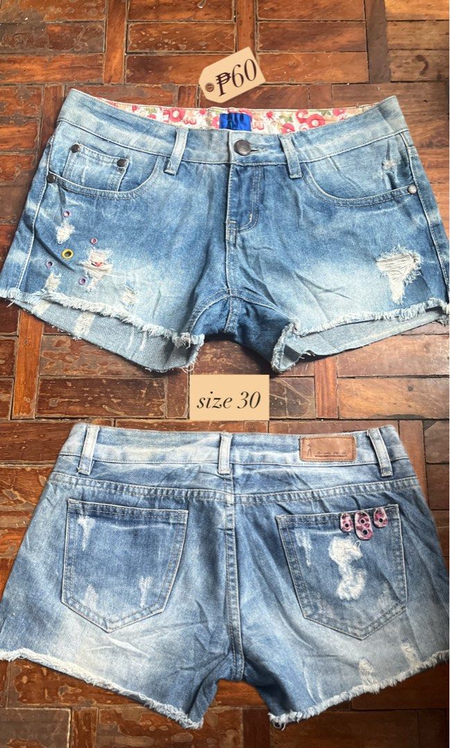 Denim Shorts Size 30 low rise (Category: Shorts) located in Mandaluyong City. Submitted by copthatgirl (Listing ID 1467478357, Image 1). Description: - Size: 30 - Wash: Classic blue denim - Style: Distressed with raw frayed hem edges - Details: Colorful decorative eyelet hardware and floral print waistband lining - Closure: Button closure with zip fly - Condition: Excellent / As described.
