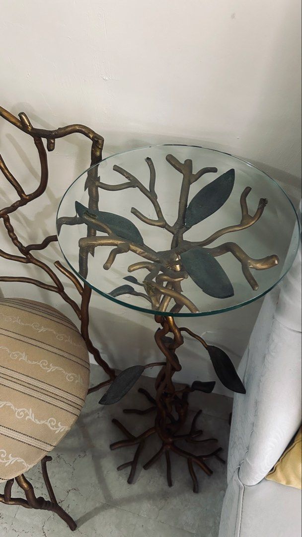 Designers unique solid metal chair and glass top side table (Category: Tables & Sets) located in General Trias. Submitted by csrtechsol61982 (Listing ID 1467381803, Image 3). Description: - Unique nature-inspired furniture set with branch and root metal frames - Stunning antiqued gold finish for an elegant look - Round side table features a thick glass top and sculptural base - Matching chair includes a comfortable padded round seat - Upholstered