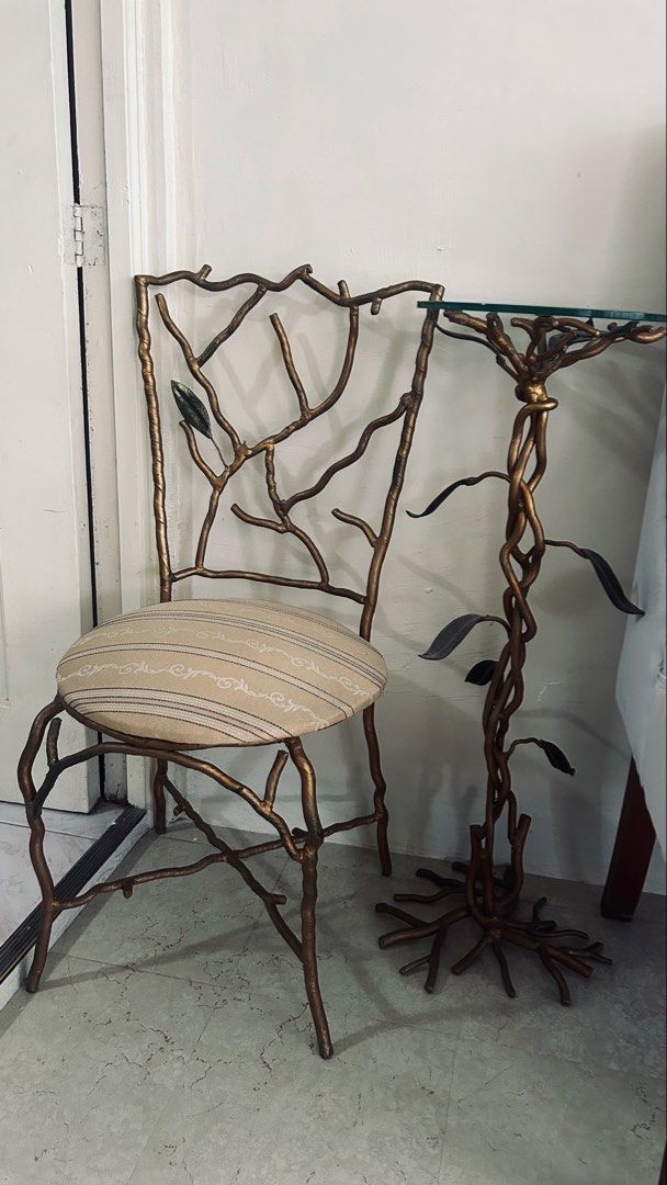 Designers unique solid metal chair and glass top side table (Category: Tables & Sets) located in General Trias. Submitted by csrtechsol61982 (Listing ID 1467381803, Image 1). Description: - Unique nature-inspired furniture set with branch and root metal frames - Stunning antiqued gold finish for an elegant look - Round side table features a thick glass top and sculptural base - Matching chair includes a comfortable padded round seat - Upholstered