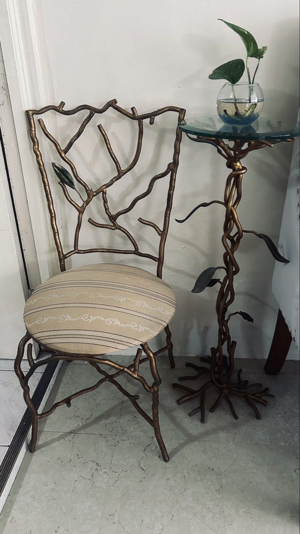 Designers unique solid metal chair and glass top side table (Category: Tables & Sets) located in General Trias. Submitted by csrtechsol61982 (Listing ID 1467381803, Image 2). Description: - Unique nature-inspired furniture set with branch and root metal frames - Stunning antiqued gold finish for an elegant look - Round side table features a thick glass top and sculptural base - Matching chair includes a comfortable padded round seat - Upholstered