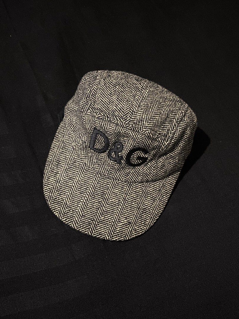 D&G Herringbone Wool Cadet Cap (Category: Caps & Hats) located in Manila. Submitted by jeproxthrift (Listing ID 1467572945, Image 1). Description: - Brand: Dolce & Gabbana (D&G) - Style: Cadet cap / Military hat - Pattern: Black and white herringbone tweed - Details: Embroidered D&G logo on the front, classic curved brim, and interior lining - Closure: Adjustable metal strap at the back for a custom fit - Condition: Excellent, timeless designer s