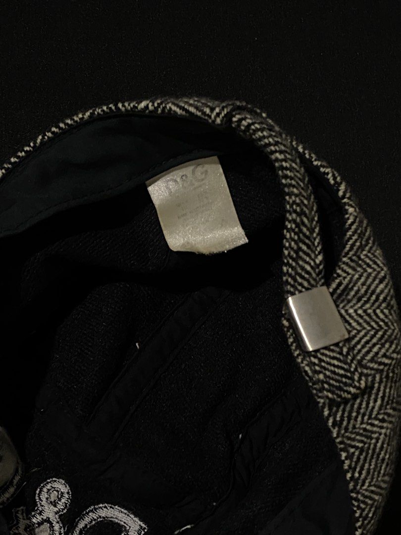 D&G Herringbone Wool Cadet Cap (Category: Caps & Hats) located in Manila. Submitted by jeproxthrift (Listing ID 1467572945, Image 3). Description: - Brand: Dolce & Gabbana (D&G) - Style: Cadet cap / Military hat - Pattern: Black and white herringbone tweed - Details: Embroidered D&G logo on the front, classic curved brim, and interior lining - Closure: Adjustable metal strap at the back for a custom fit - Condition: Excellent, timeless designer s