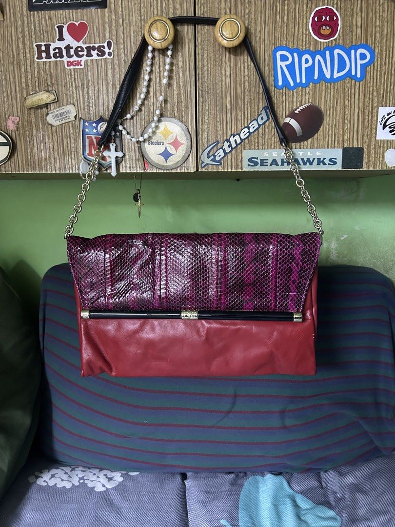 Diane Von Furstenberg Red and Purple Python Shoulder Bag (Category: Shoulder Bags) located in Quezon City. Submitted by thriftxgoods (Listing ID 1467448685, Image 1). Description: Diane Von Furstenberg convertible shoulder bag and clutch. Vibrant red leather body paired with a magenta and black python-embossed flap. Gold hardware accents with a metal frame opening and DVF logo detailing. Structured silhouette with chain-link straps and a dark pat