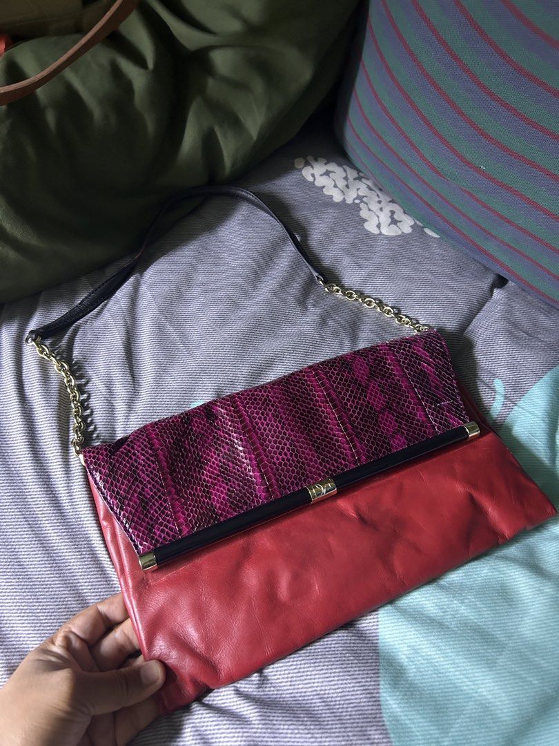 Diane Von Furstenberg Red and Purple Python Shoulder Bag (Category: Shoulder Bags) located in Quezon City. Submitted by thriftxgoods (Listing ID 1467448685, Image 3). Description: Diane Von Furstenberg convertible shoulder bag and clutch. Vibrant red leather body paired with a magenta and black python-embossed flap. Gold hardware accents with a metal frame opening and DVF logo detailing. Structured silhouette with chain-link straps and a dark pat