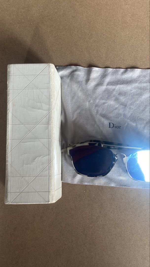 Dior Abstract Sunglasses (Category: Sunglasses & Eyewear) located in Cebu City. Submitted by nakajack (Listing ID 1467553768, Image 2). Description: - Brand: Dior Abstract sunglasses - Frame: Chic tortoiseshell pattern with double brow bar and metal accents - Lenses: Blue mirrored lenses with visible surface scratches from handling/use - Inclusions: Original white Dior branded case and grey cleaning cloth - Condition note: Box shows minor exterio