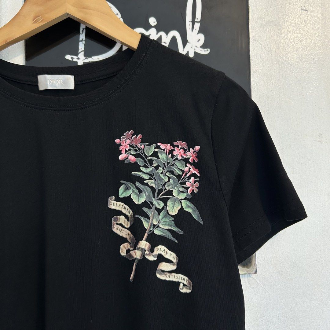 Dior Black Botanical Floral Print Tee Size L (Category: Tshirts & Polo Shirts ) located in Manila. Submitted by jakes_thrift_shop (Listing ID 1467509657, Image 2). Description: - Dior black short-sleeve t-shirt - Size: L - Material: 100% cotton, made in Italy - Design: Detailed botanical flower graphic print with vintage-style scientific illustration text on the front chest - Details: Classic crew neck collar with Dior woven neck label - Conditio