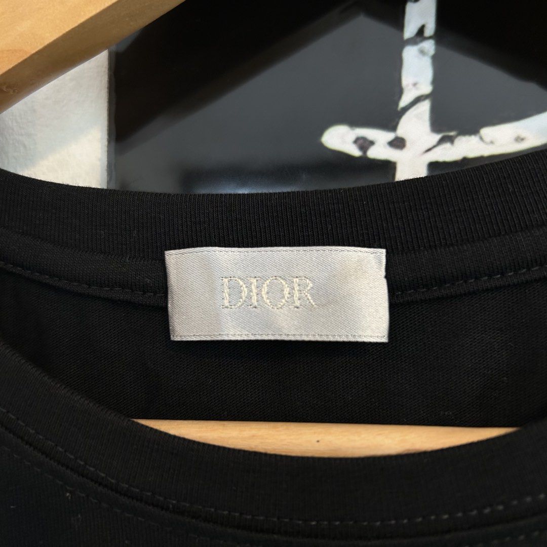 Dior Black Botanical Floral Print Tee Size L (Category: Tshirts & Polo Shirts ) located in Manila. Submitted by jakes_thrift_shop (Listing ID 1467509657, Image 3). Description: - Dior black short-sleeve t-shirt - Size: L - Material: 100% cotton, made in Italy - Design: Detailed botanical flower graphic print with vintage-style scientific illustration text on the front chest - Details: Classic crew neck collar with Dior woven neck label - Conditio