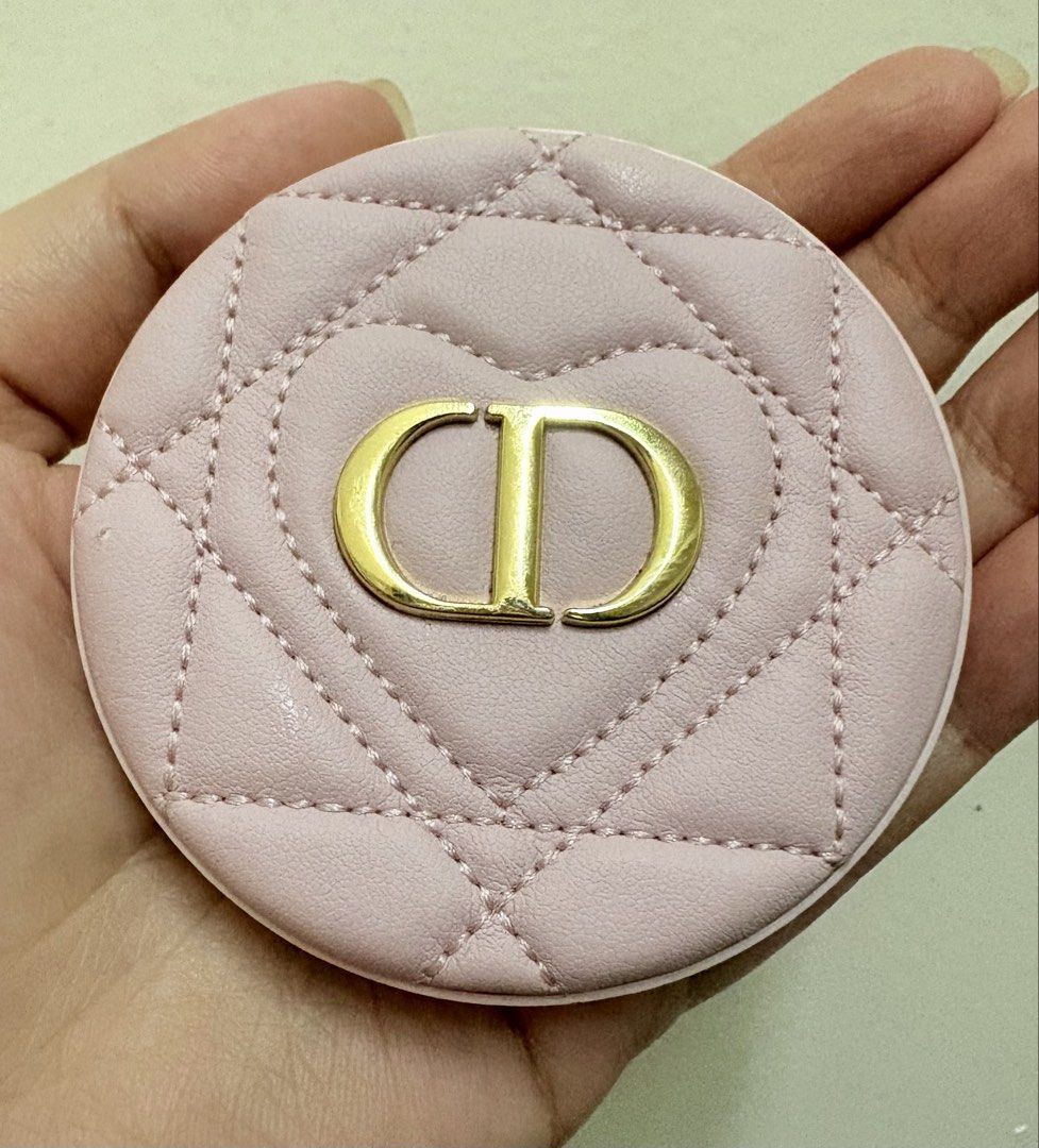 Dior Pink Quilted CD Compact Mirror (Category: Makeup) located in Manila. Submitted by alyannaros79007 (Listing ID 1467512690, Image 1). Description: - Brand: Dior - Material: Pink quilted faux leather - Design: Gold CD logo inside a stitched heart shape on the front, plain pink back - Interior: Dual mirrors for easy touch-ups - Size: Pocket-sized and compact, convenient for everyday use and travel - No more box.