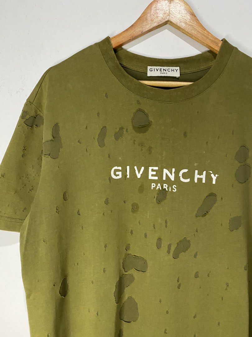 GIVENCHY DISTRESSED SHIRT (Category: Tshirts & Polo Shirts ) located in Jaen. Submitted by oshimamark58418 (Listing ID 1467524401, Image 3). Description: - Brand: Givenchy - Style: Distressed / Shredded Streetwear T-Shirt - Color: Olive Green - Size: XL - Features: Bold Givenchy Paris front logo, heavy distressing with artistic holes and cutouts, comfortable cotton fabric - Condition: Pre-owned with intentional designer-style distressing.
