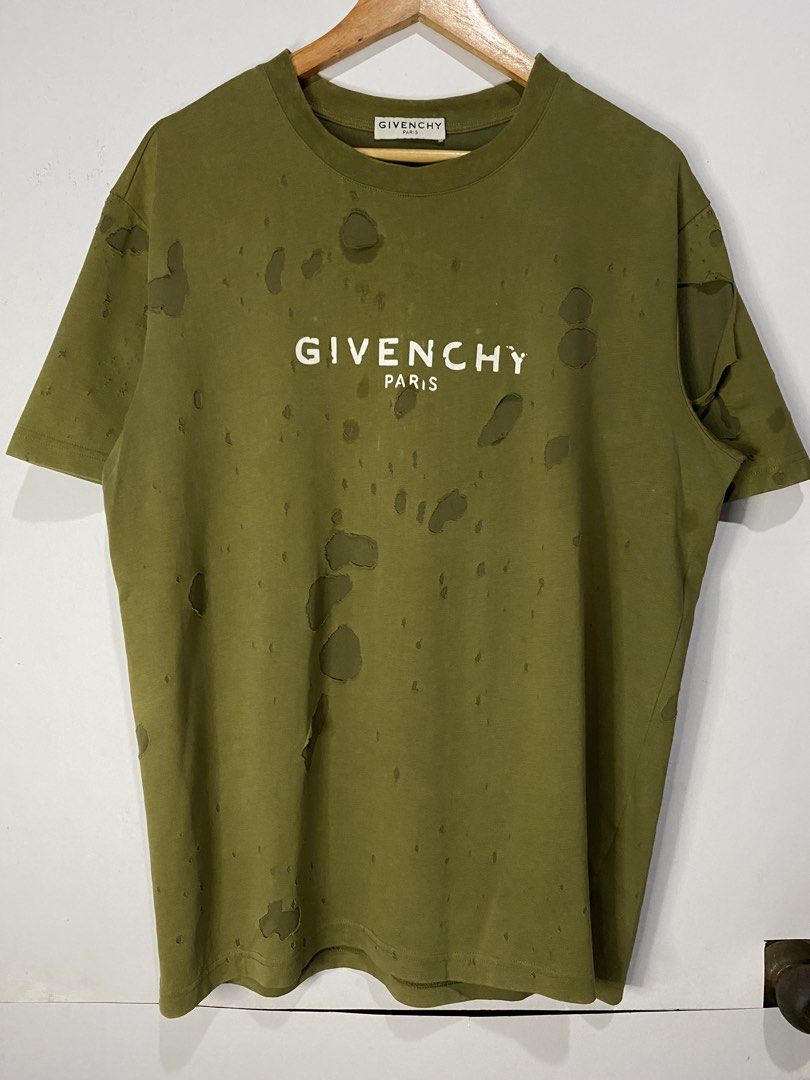 GIVENCHY DISTRESSED SHIRT (Category: Tshirts & Polo Shirts ) located in Jaen. Submitted by oshimamark58418 (Listing ID 1467524401, Image 1). Description: - Brand: Givenchy - Style: Distressed / Shredded Streetwear T-Shirt - Color: Olive Green - Size: XL - Features: Bold Givenchy Paris front logo, heavy distressing with artistic holes and cutouts, comfortable cotton fabric - Condition: Pre-owned with intentional designer-style distressing.