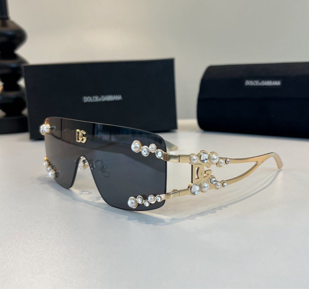 Dolce & Gabbana Sunglasses (Category: Sunglasses & Eyewear) located in Paranaque City. Submitted by kyriaki_thrift_shop (Listing ID 1467403216, Image 3). Description: - Brand: Dolce & Gabbana - Style: Oversized shield sunglasses with dark lenses - Details: Gold-tone metal arms accented with pearls and clear crystals, featuring the iconic DG logo on the temples and top lens corner - Condition: Brand new, never worn out, stored clean - Inclusions: 