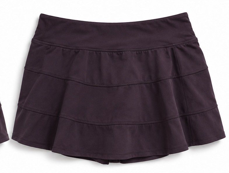 Dot 6 Lululemon Pleated Athletic Skort Deep Plum (Category: Skirts) located in Valencia. Submitted by bruuuuh (Listing ID 1467550574, Image 2). Description: - Brand: Lululemon - Color: Deep Plum - Style: Tiered ruffled design with panel seams - Features: Built-in shorts and secure back waistband zippered pocket - Fabric: Smooth, high-performance material - Ideal For: Tennis, running, or casual wear.