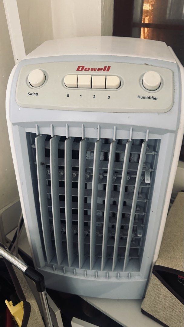 Dowell Air Cooler (Category: Fans) located in General Trias. Submitted by csrtechsol61982 (Listing ID 1467381908, Image 2). Description: - Brand/Model: Dowell Tower Fan with built-in humidifier - Color: Light grey and white plastic body - Settings: 3 speed levels (0 to 3), swing button, and humidifier dial - Condition: Dusty on the front grilles and louvers; needs thorough cleaning before use - Usage: Ideal standard size for tabletop or floor sta