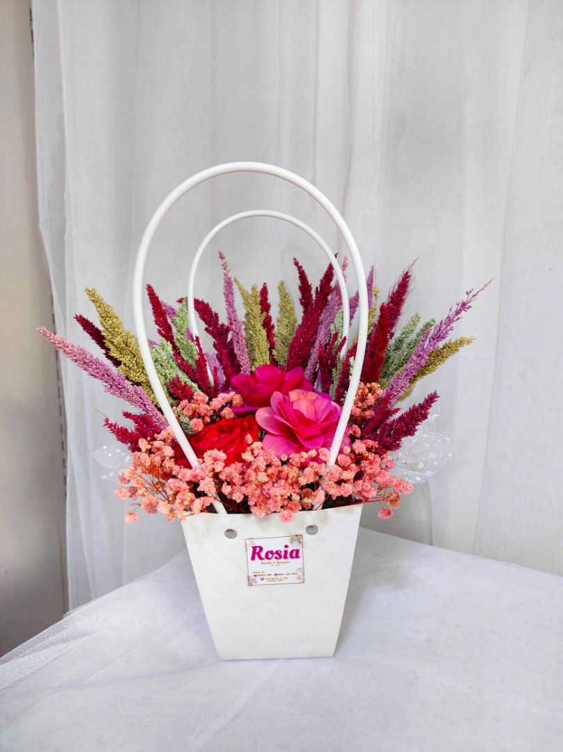 Dried Floral Arrangement Basket (Category: Flowers & Bouquets) located in San Fernando. Submitted by lrrndc (Listing ID 1467579871, Image 3). Description: - Handcrafted dried floral arrangement in a stylish basket with handles - Available color themes: Blue, Pink, Purple, Red, and Yellow - Package includes: Decorative basket, paper bag, fairy light, and a free printed greeting card - Perfect for gifts, home decor, and special occasions - Fulfillm