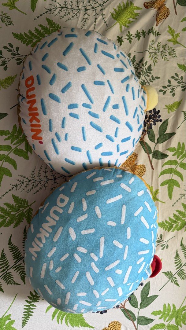 Dunkin Donuts Donut Pillows Set of 2 (Category: Bedding & Towels) located in Manila. Submitted by basiliocla11530 (Listing ID 1467511676, Image 1). Description: - Set of 2 Dunkin' donut shaped plush pillows - Includes 1 white base with blue sprinkles and 1 blue base with white sprinkles - Features the iconic Dunkin logo along the side - Made with ultra-soft plush material - Perfect aesthetic addition for your bedroom setup or couch - Selling both