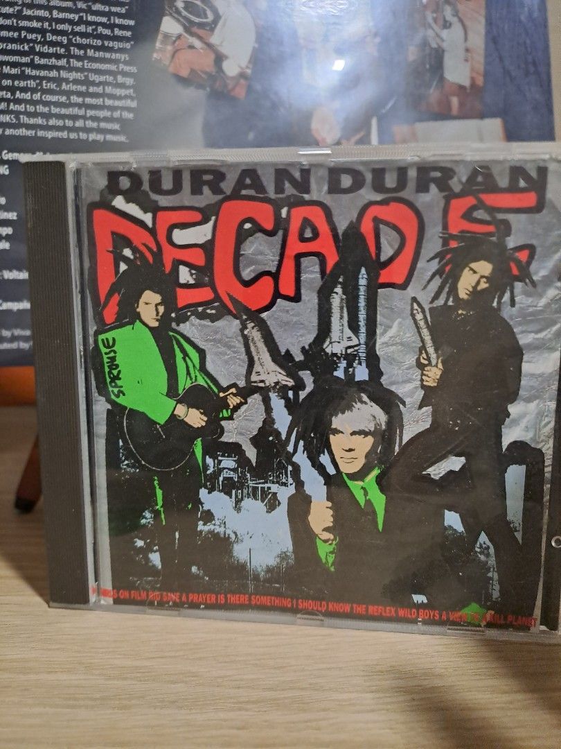 Duran Duran Decade CD Album (Category: CDs & DVDs) located in Las Pinas. Submitted by cobieshop (Listing ID 1467506753, Image 1). Description: - Item: Duran Duran Decade Audio CD - Packaging: Standard jewel case with minor storage wear - Design: Iconic silver cover with red text and vertical tracklist - Condition: Tested and plays perfectly - Perfect for: 80s music collectors and fans.