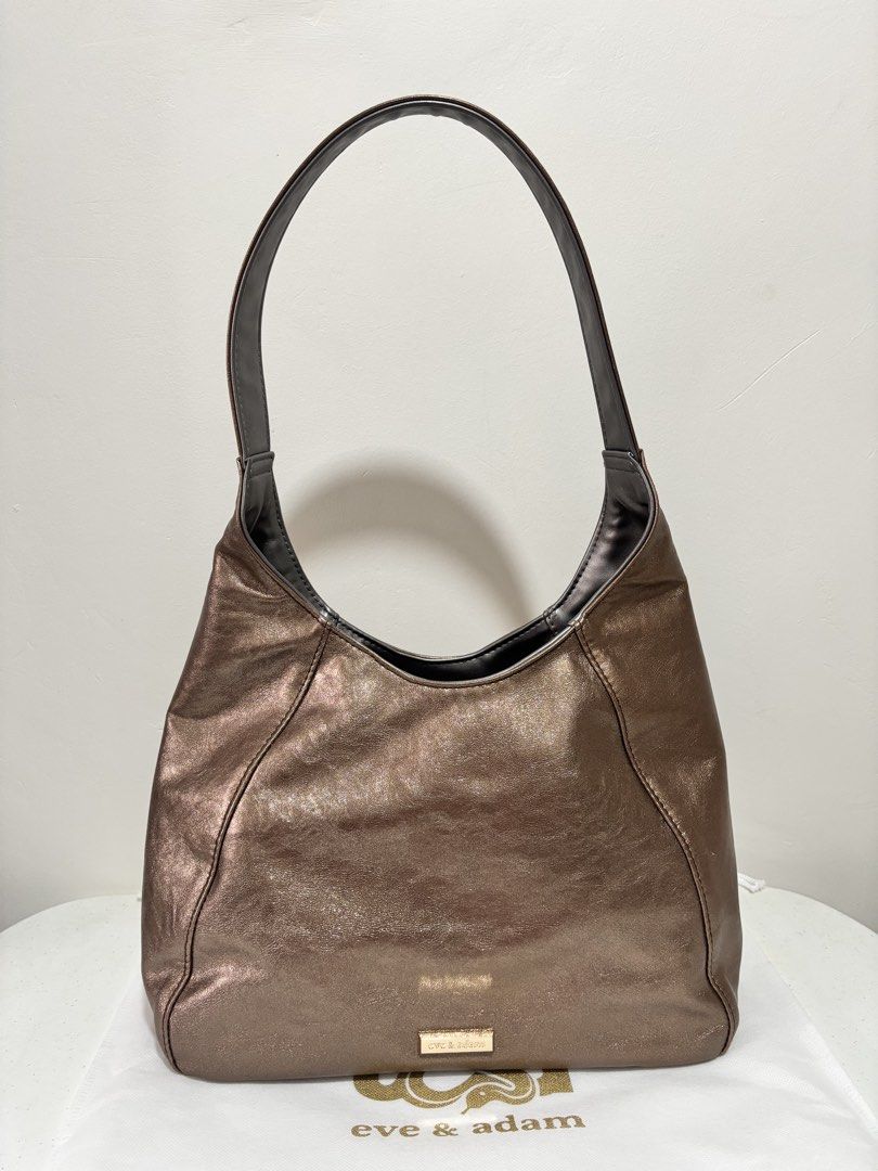 E&A Ava Mini Reversible Hobo Bag - Bronze/met.gray (Category: Luxury Bags & Wallets) located in Taguig. Submitted by yumi9121 (Listing ID 1467455131, Image 1). Description: Like new! 10/10 excellent condition RFS: Rarely used (no issue, no flaw) - Reversible design (2 looks in 1 bag!) - Material: Premium vegan leather in both sides with wrinkled metallic finish on 1 side - Closure: Double side magnetic lock - Pockets: 1 exterior zipper back pocke