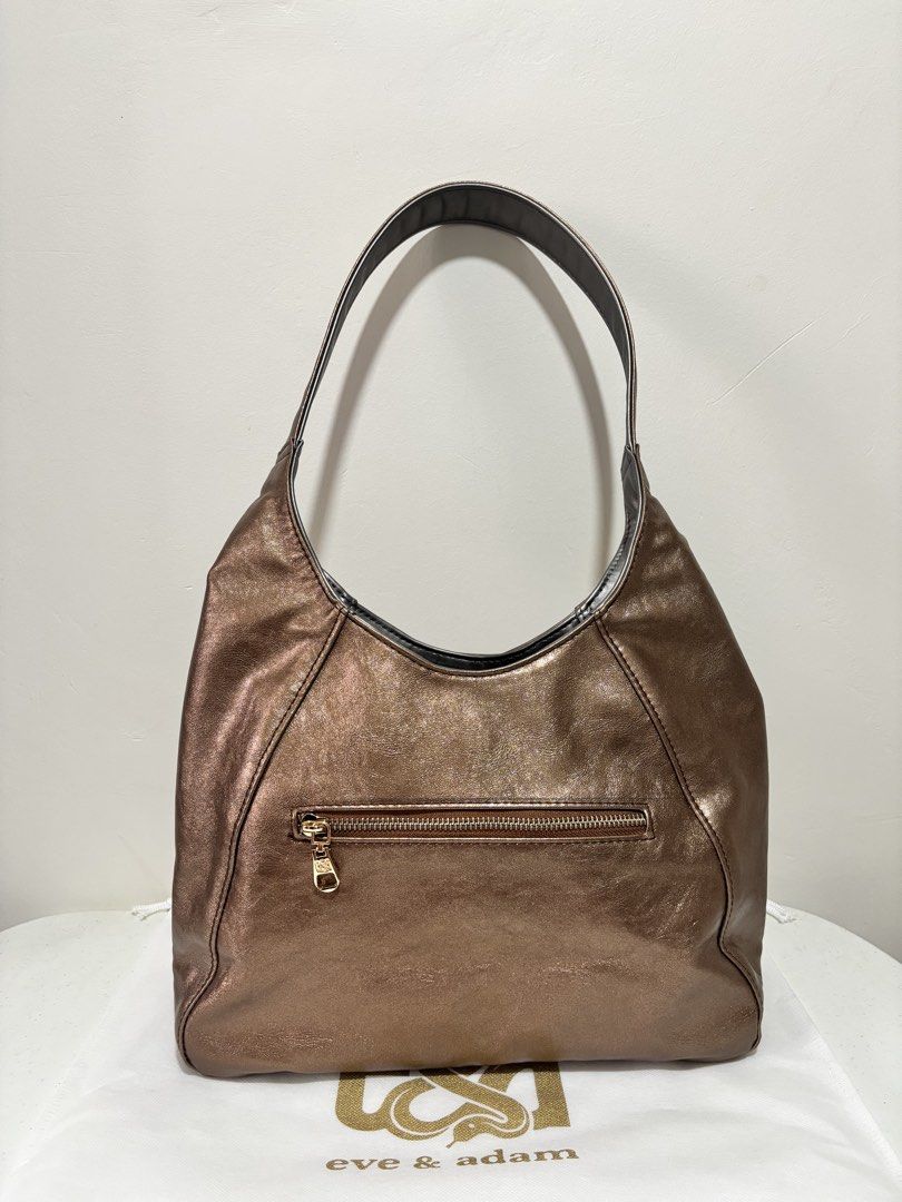 E&A Ava Mini Reversible Hobo Bag - Bronze/met.gray (Category: Luxury Bags & Wallets) located in Taguig. Submitted by yumi9121 (Listing ID 1467455131, Image 2). Description: Like new! 10/10 excellent condition RFS: Rarely used (no issue, no flaw) - Reversible design (2 looks in 1 bag!) - Material: Premium vegan leather in both sides with wrinkled metallic finish on 1 side - Closure: Double side magnetic lock - Pockets: 1 exterior zipper back pocke