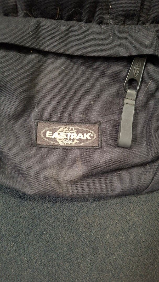 Eastpak Black Backpack (Category: Backpacks) located in Marikina City. Submitted by makimki (Listing ID 1467401310, Image 2). Description: - Authentic black Eastpak backpack made from durable canvas - Features multiple zipped compartments and secure buckle straps - Fully working zippers with spacious main compartment and front pocket - Versatile for school, work, travel, or daily commute - Condition: Good and functional, with slight dust/lint on 