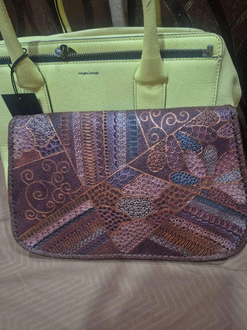 Embossed Leather Floral Patchwork Crossbody Bag with Chain (Category: Cross-body Bags) located in Iloilo. Submitted by gorgeoustatz (Listing ID 1467523124, Image 2). Description: - Material: Premium brown leather with all-over floral and patchwork embossed pattern - Closure: Flap top with a secure gold-tone metal clasp - Strap: Elegant thin gold chain for shoulder or crossbody wear - Design: Structured gusseted sides with piped leather edges - Ca
