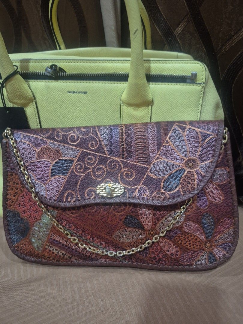Embossed Leather Floral Patchwork Crossbody Bag with Chain (Category: Cross-body Bags) located in Iloilo. Submitted by gorgeoustatz (Listing ID 1467523124, Image 1). Description: - Material: Premium brown leather with all-over floral and patchwork embossed pattern - Closure: Flap top with a secure gold-tone metal clasp - Strap: Elegant thin gold chain for shoulder or crossbody wear - Design: Structured gusseted sides with piped leather edges - Ca