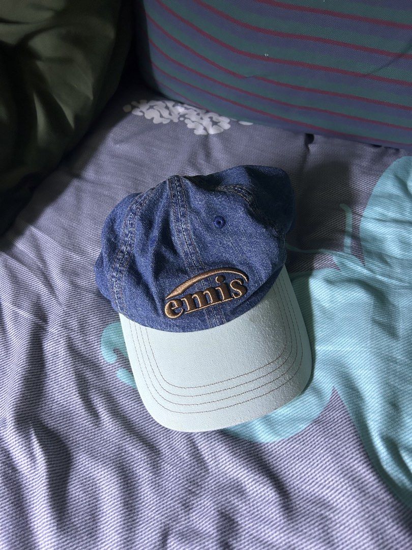 Emis Denim Baseball Cap Blue Light Blue (Category: Caps & Hats) located in Quezon City. Submitted by thriftxgoods (Listing ID 1467449870, Image 1). Description: - Brand: Emis - Style: Denim baseball cap with dark blue crown and light blue curved brim - Details: Embroidered brown and cream logo patch on the front - Fit: Adjustable strapback closure with branded metal buckle - Material: 100% cotton (verified via interior tags) - Condition: Clean in