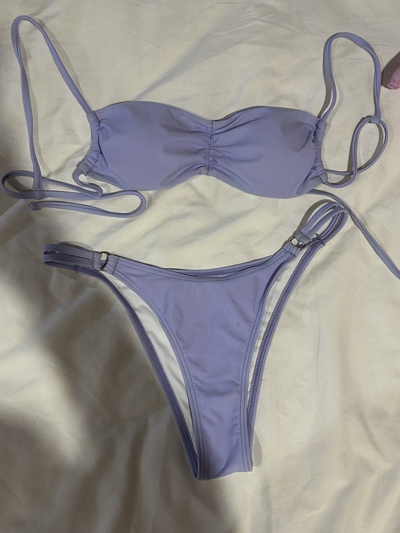 Esseantials Lavender Ruched Bandeau Bikini Set (Category: Bikinis & Swimsuits) located in Cebu City. Submitted by shopmikascloset (Listing ID 1467370607, Image 1). Description: - Style: Two-piece bikini set in soft lavender - Top: Bandeau with center ruching and thin tie straps - Bottoms: High-cut leg style with side strap details and metal ring hardware - Interior: Clean white lining - Condition: Excellent, clean fabric with no stains or wear vi