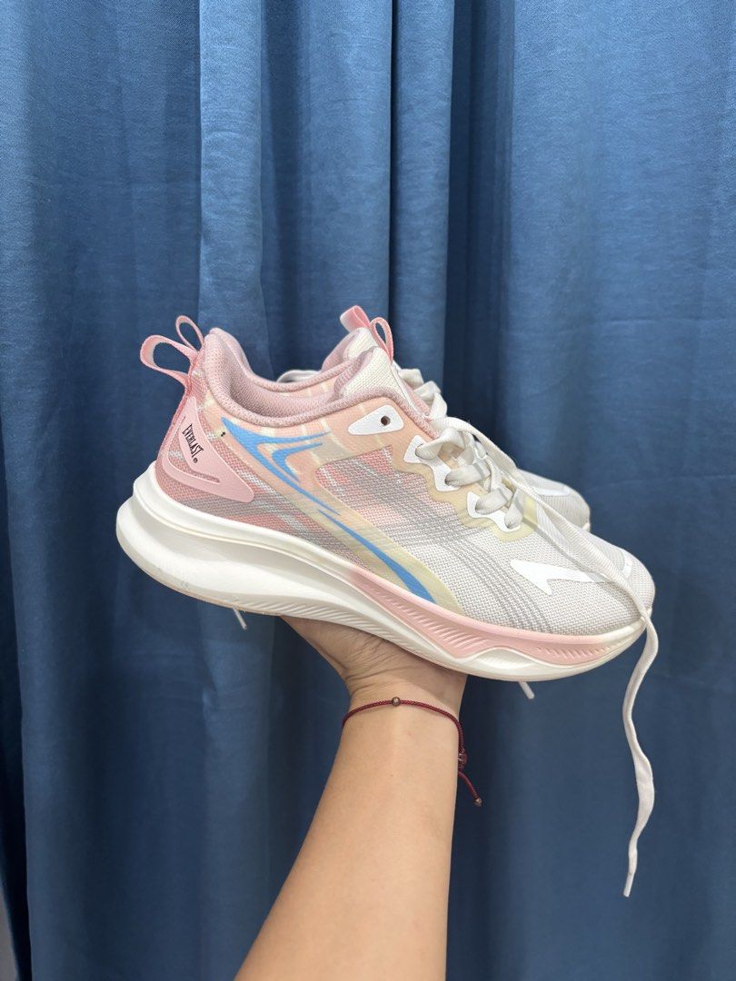 Everlast Pink White Athletic Running Shoes (Category: Sneakers) located in Digos. Submitted by kathydiane76376 (Listing ID 1467529127, Image 1). Description: - Brand: Everlast - Color: Pastel pink and white with blue and yellow accents - Material: Lightweight mesh upper with a chunky white sole - Features: Pull tab at the back heel, includes white laces - Best for: Workouts, daily walks, or casual everyday wear.