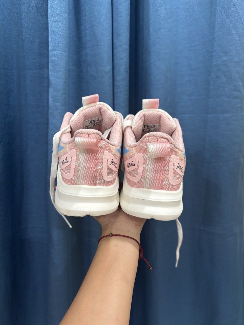 Everlast Pink White Athletic Running Shoes (Category: Sneakers) located in Digos. Submitted by kathydiane76376 (Listing ID 1467529127, Image 2). Description: - Brand: Everlast - Color: Pastel pink and white with blue and yellow accents - Material: Lightweight mesh upper with a chunky white sole - Features: Pull tab at the back heel, includes white laces - Best for: Workouts, daily walks, or casual everyday wear.