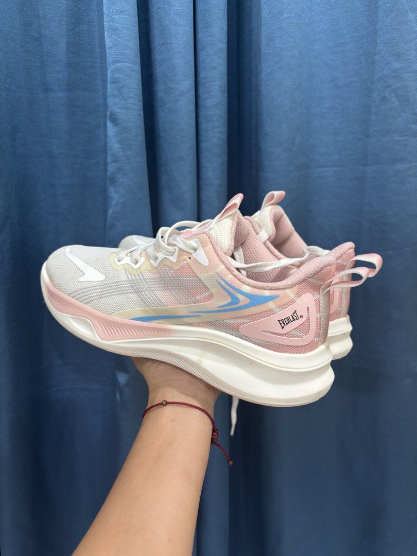 Everlast Pink White Athletic Running Shoes (Category: Sneakers) located in Digos. Submitted by kathydiane76376 (Listing ID 1467529127, Image 3). Description: - Brand: Everlast - Color: Pastel pink and white with blue and yellow accents - Material: Lightweight mesh upper with a chunky white sole - Features: Pull tab at the back heel, includes white laces - Best for: Workouts, daily walks, or casual everyday wear.