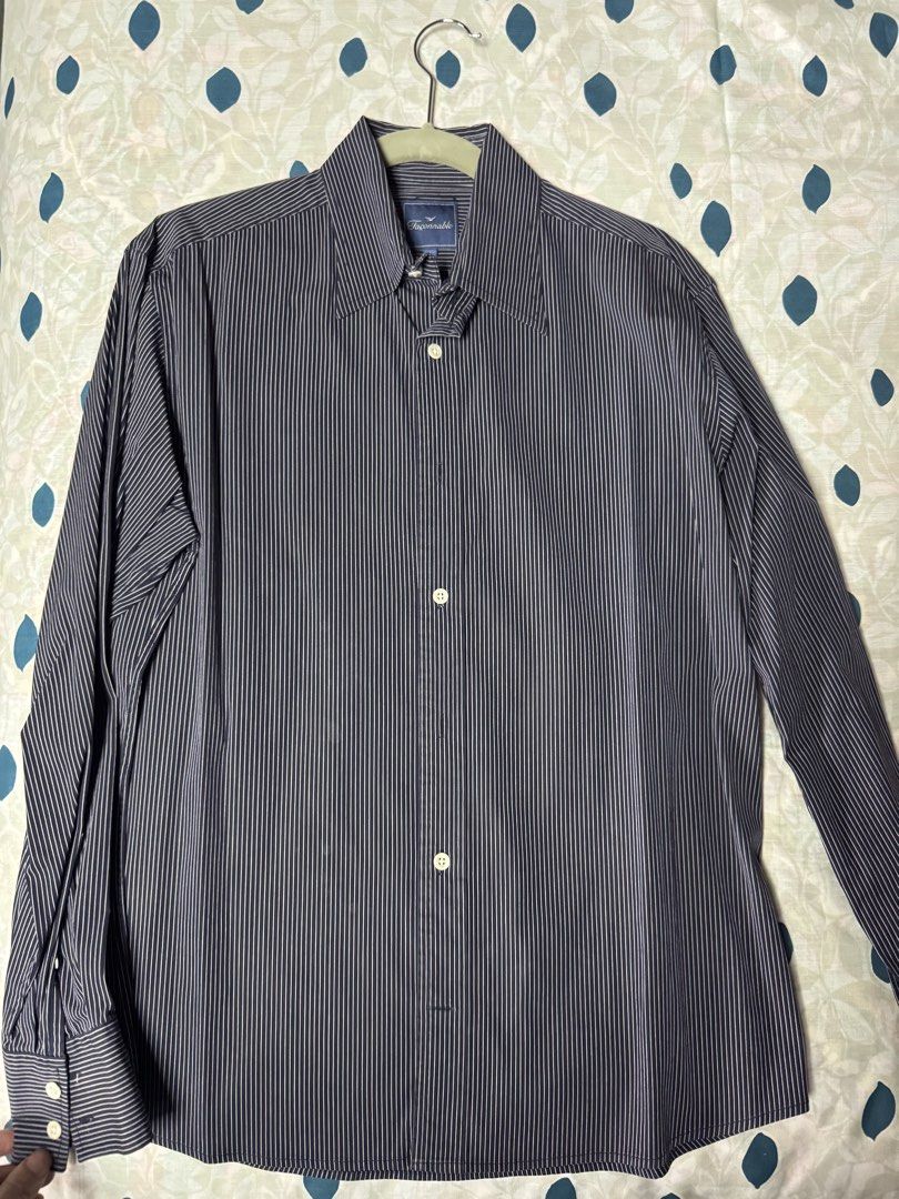 Façonnable Pinstripe Long Sleeve Button-Up Shirt (Category: Formal Shirts) located in Manila. Submitted by seangoart (Listing ID 1467444995, Image 1). Description: - Brand: Façonnable - Color: Navy blue with white pinstripes - Size: L (Tag inside collar) - Style: Long sleeves, standard collar, front button closure - Condition: Clean fabric, structured fit - Versatility: Ideal for office wear or smart-casual occasions.