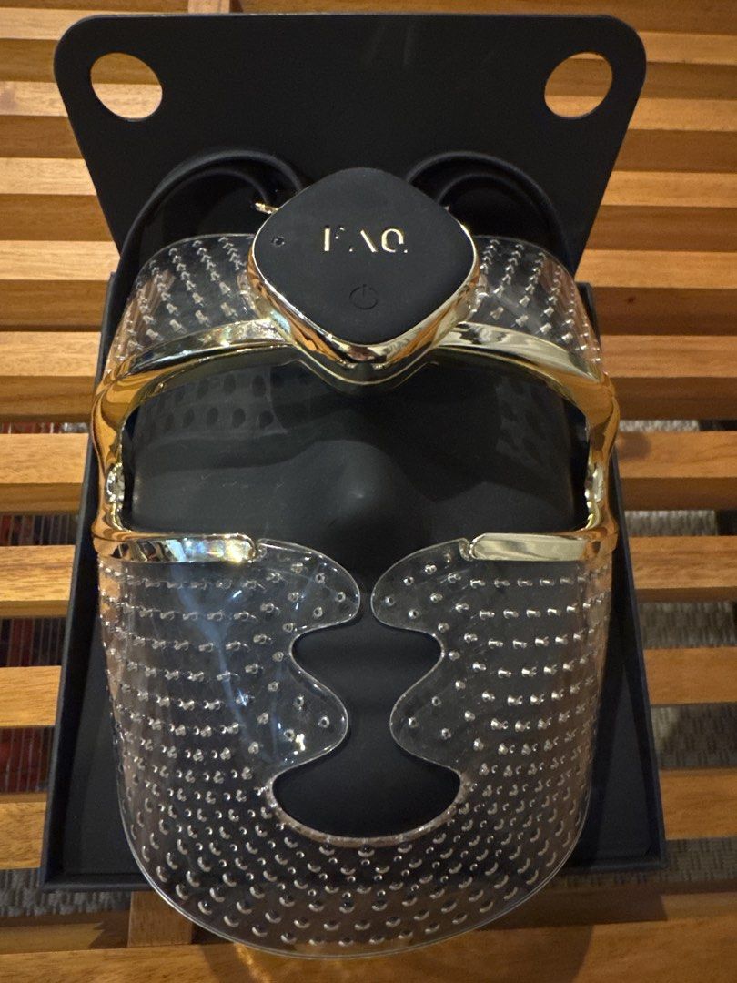 FAQ 202 Anti-Aging Silicone LED Face Mask (Category: Face Care) located in Makati City. Submitted by branded_merch (Listing ID 1467524850, Image 1). Description: - Brand: FAQ 202 Anti-Aging LED Face Mask - Condition: Tried once, kept safely in its original box - Design: Elegant clear silicone material with luxury gold trim and a central forehead power control - Features: Multiple LED light points across the transparent surface and built-in back s