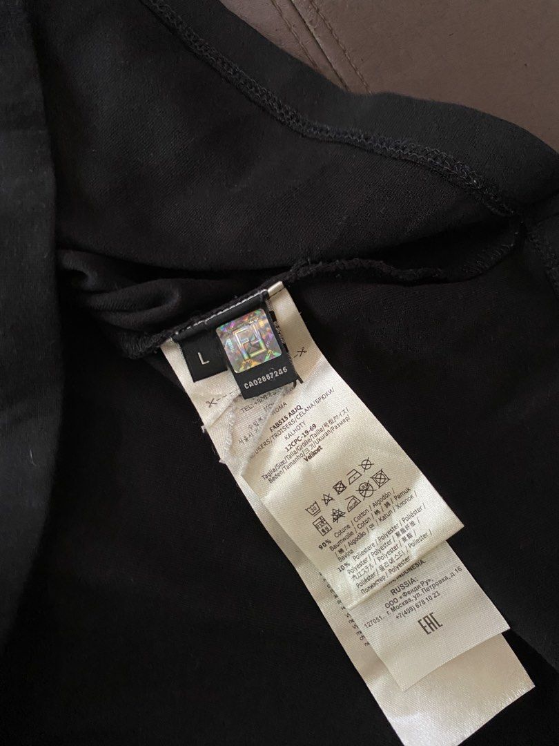 Fendi (Category: Coats, Jackets and Outerwear) located in Olongapo. Submitted by WAVYT (Listing ID 1467434339, Image 3). Description: - Brand: Fendi - Style: Mock neck long sleeve shirt - Color: Black with multi-colored embroidered logo patch on chest - Size: L - Material: 90% cotton, 10% polyester blend - Origin: Made in Italy - Condition/Details: Includes interior care tags and authentication hologram.