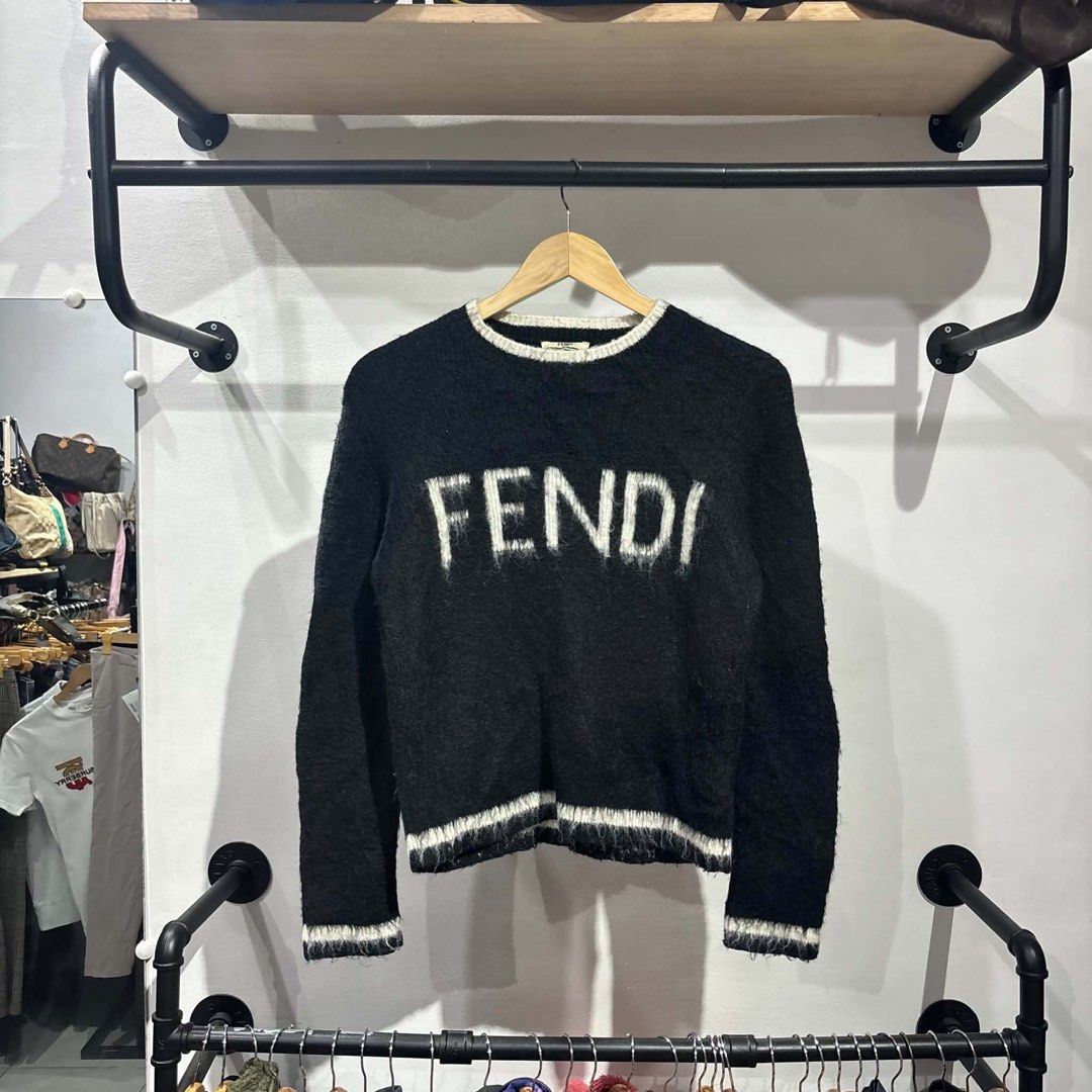 Fendi Roma Wool Pullover Sweater Black White Size 38 (Category: Longsleeves) located in Bambang. Submitted by heats777 (Listing ID 1467502359, Image 2). Description: - Brand: Fendi Roma - Style: Crew neck wool pullover sweater - Color: Black with white ribbed collar, cuffs, and hem - Details: Large white fuzzy FENDI chest lettering - Size: Tagged size 38 - Material: 95% wool - Origin: Made in Italy - Condition: Excellent designer knitwear, warm a
