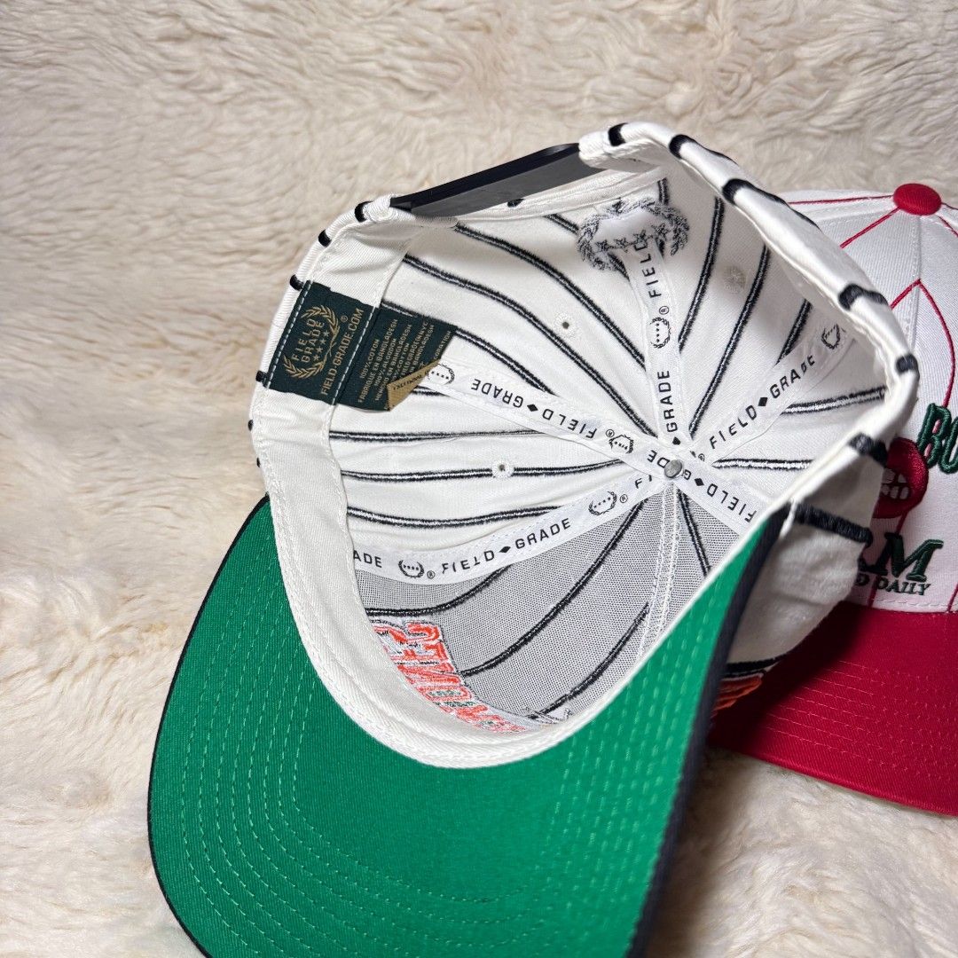 Field Grade Baseball Caps Pinstripe Snapbacks (Category: Caps & Hats) located in Manila. Submitted by westcity.mnl (Listing ID 1467512219, Image 3). Description: - Brand: Field Grade - Quantity: 2 snapback caps with pinstripe patterns - Cap 1 Details: Black brim with 'One Of Them Ones' embroidery - Cap 2 Details: Red brim with 'Cherry Bomb Farm' graphics, cherry patch at the back, and green underbrims - Size: Adjustable snap closure (fits most) -
