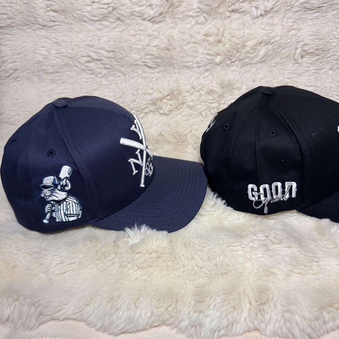 Field Grade NYC Snapback Hats (Navy & Black) (Category: Caps & Hats) located in Manila. Submitted by westcity.mnl (Listing ID 1467512364, Image 2). Description: Two Field Grade snapback hats available. One navy blue, one black. Both feature embroidered NYC lettering with crossed baseball bats and knuckle duster graphic on front. Side features a rat character on the navy cap and "Goon Squad" text on the black cap. Contrast green underbill and bran