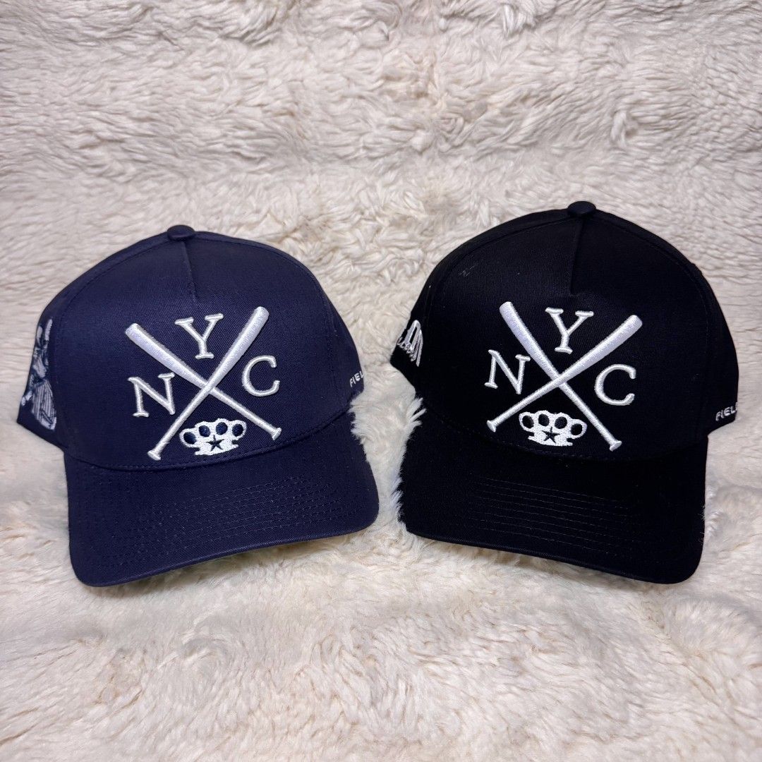 Field Grade NYC Snapback Hats (Navy & Black) (Category: Caps & Hats) located in Manila. Submitted by westcity.mnl (Listing ID 1467512364, Image 1). Description: Two Field Grade snapback hats available. One navy blue, one black. Both feature embroidered NYC lettering with crossed baseball bats and knuckle duster graphic on front. Side features a rat character on the navy cap and "Goon Squad" text on the black cap. Contrast green underbill and bran